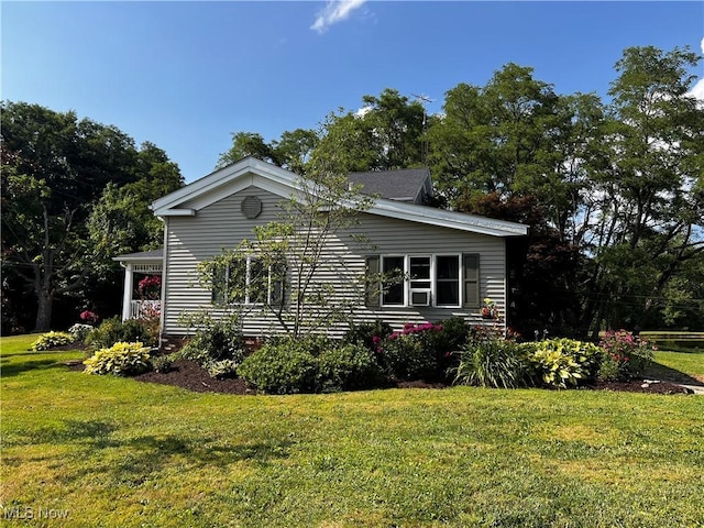 view of property exterior featuring a lawn