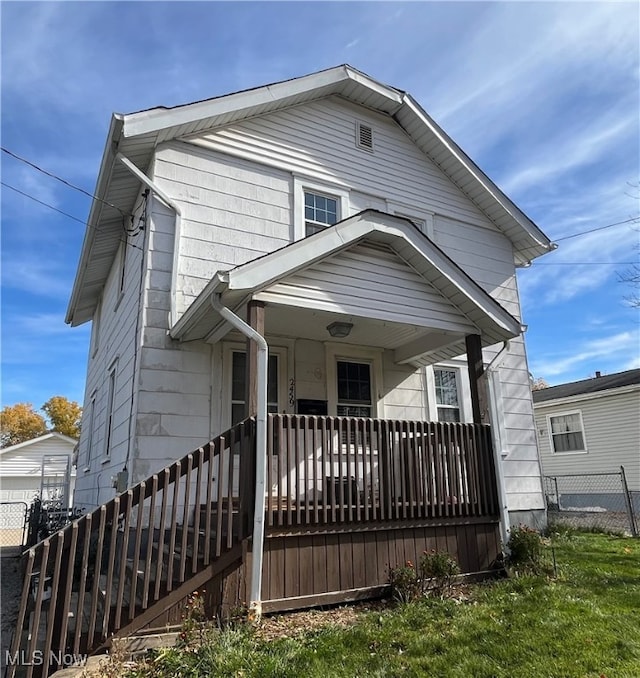 bungalow-style home with a front yard