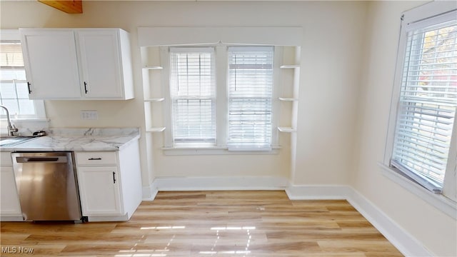 kitchen with white cabinetry, light hardwood / wood-style flooring, dishwasher, and light stone counters