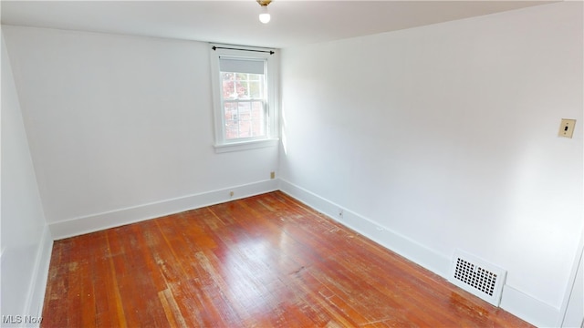 unfurnished room with wood-type flooring