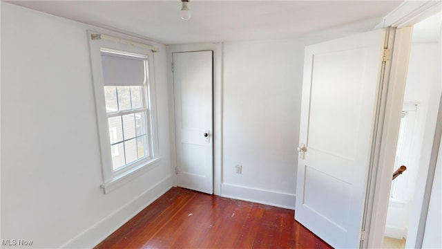 unfurnished bedroom with dark hardwood / wood-style floors