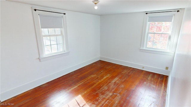 spare room featuring wood-type flooring