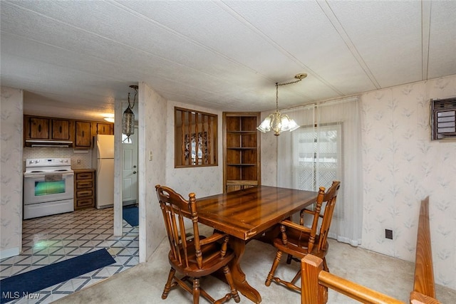 dining area featuring a textured ceiling and a chandelier