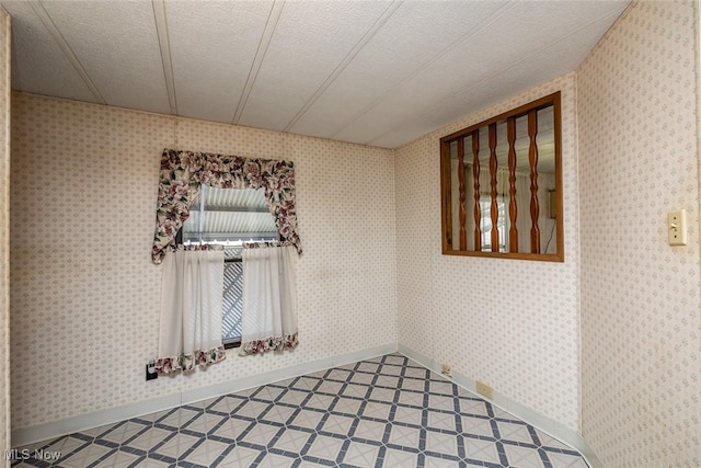 unfurnished room featuring a textured ceiling