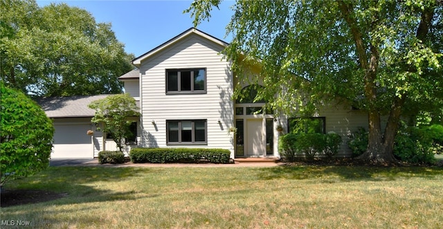 view of front facade featuring a front yard and a garage