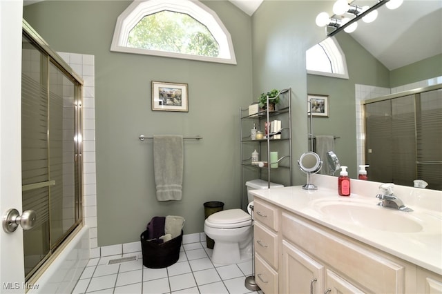 full bathroom with lofted ceiling, toilet, tile patterned flooring, bath / shower combo with glass door, and vanity