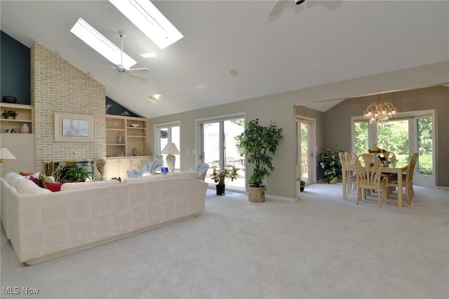 432 Chipping Ln, Chagrin Falls, OH 44023 - carpeted living area featuring lofted ceiling with skylight, ceiling fan with notable chandelier, and baseboards