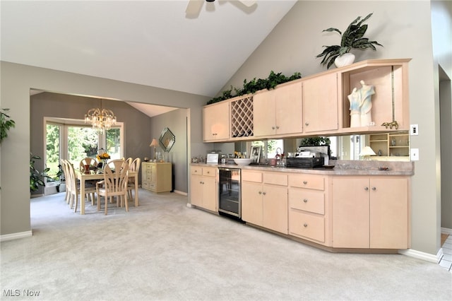 kitchen featuring wine cooler, light brown cabinets, pendant lighting, and light colored carpet