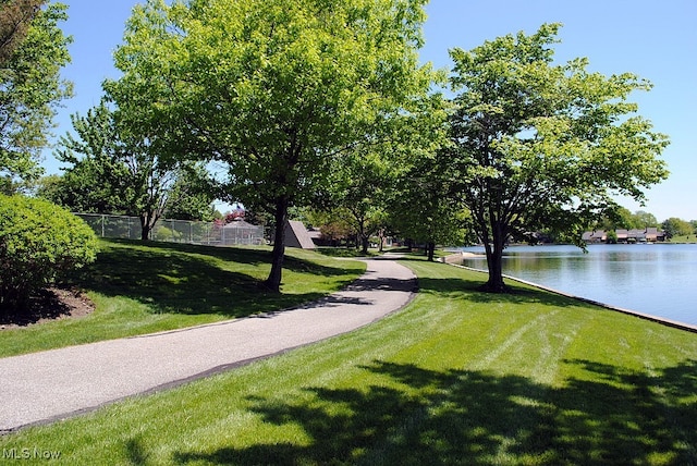 surrounding community featuring a water view and a yard