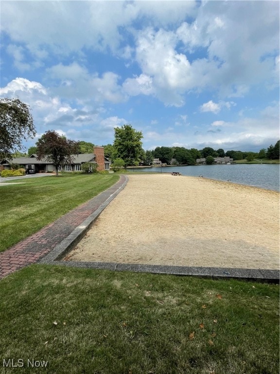 view of property's community featuring a water view and a yard