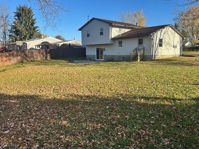 rear view of house with a yard