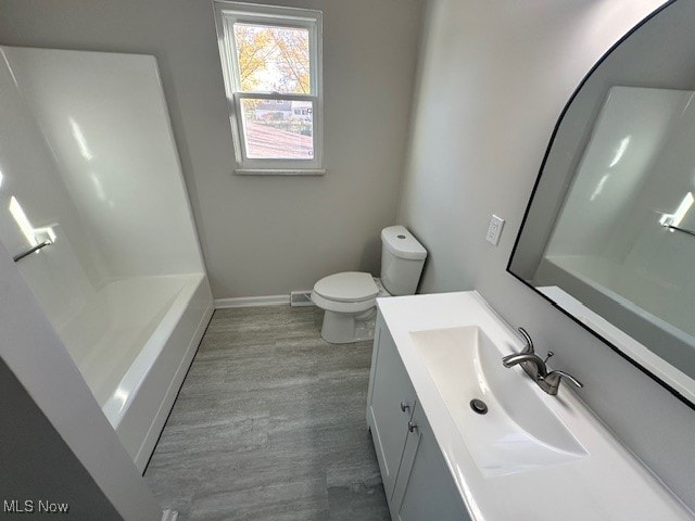 bathroom featuring vanity, toilet, and wood-type flooring