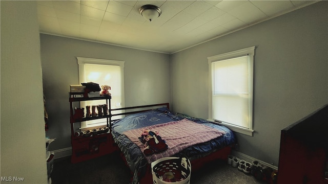 bedroom with dark colored carpet and ornamental molding