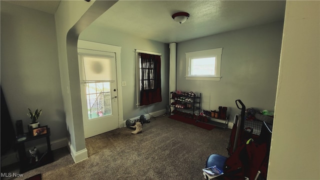 misc room with dark colored carpet