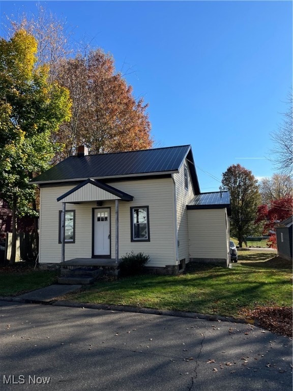 bungalow-style house featuring a front yard