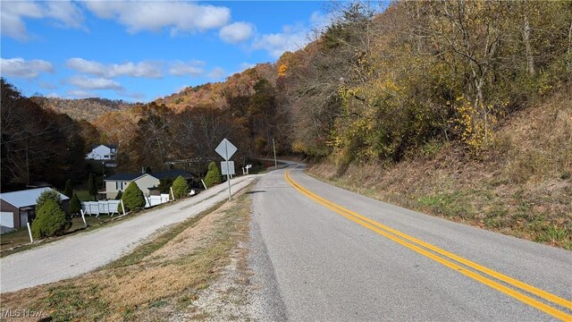 7517 N Fork Rd, Pine Grove, WV 26419 - view of asphalt street featuring a mountain view, traffic signs, and a view of trees