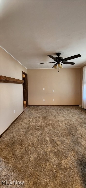 spare room featuring carpet flooring and ceiling fan