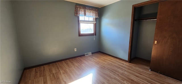 unfurnished bedroom featuring hardwood / wood-style floors and a closet