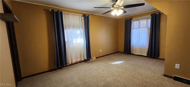 carpeted empty room with ornamental molding and ceiling fan