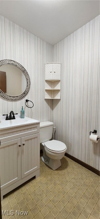 bathroom featuring toilet, vanity, and tile patterned floors