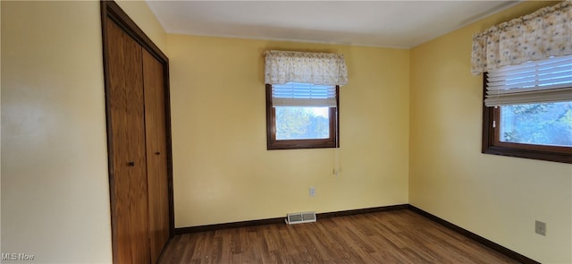 unfurnished bedroom with hardwood / wood-style flooring