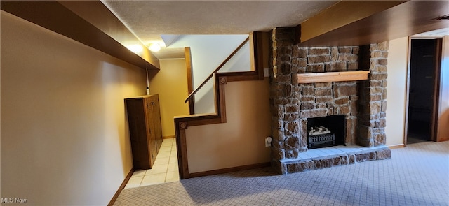 unfurnished living room with a textured ceiling, a fireplace, and light colored carpet