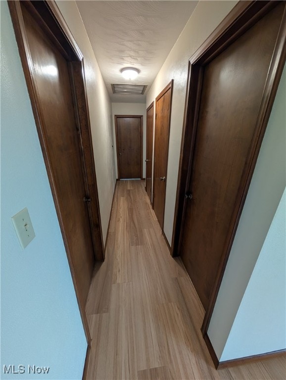 hall with light hardwood / wood-style floors