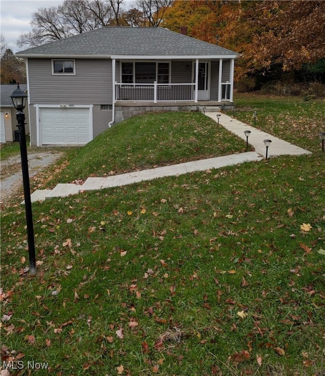 view of front facade featuring a porch, a front lawn, and a garage