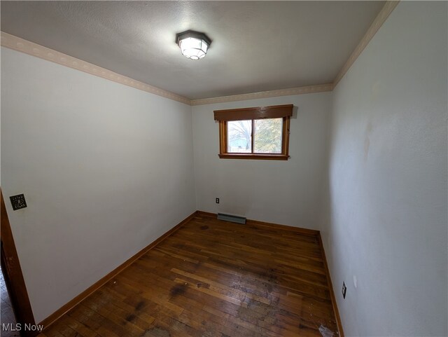 spare room featuring dark wood-type flooring