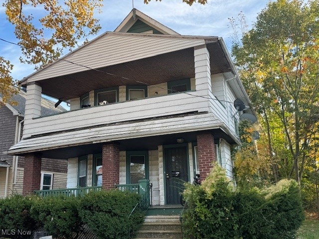 view of front of property with a porch and a balcony