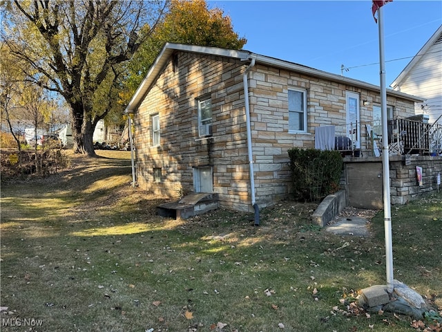 view of side of home with a lawn