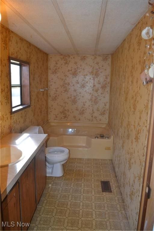 full bathroom with vanity, toilet, tub / shower combination, and a textured ceiling