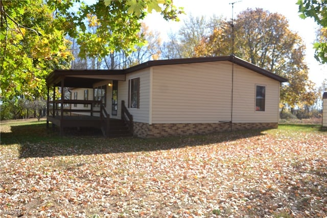 view of side of home with a deck