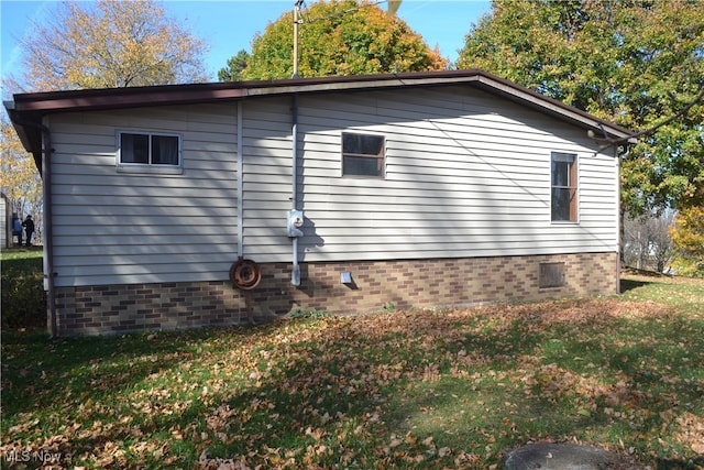 view of side of property with a yard