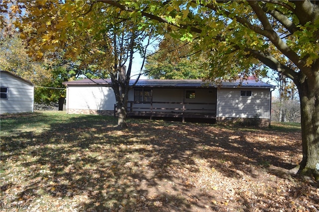 back of house with a deck