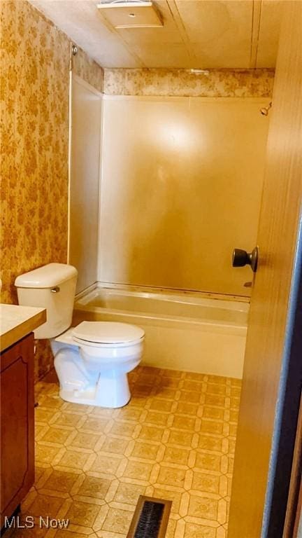 full bathroom with vanity, bathing tub / shower combination, and toilet