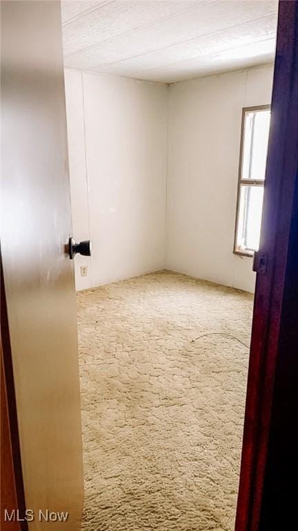 unfurnished room featuring carpet flooring