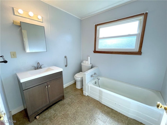 bathroom with vanity, a tub to relax in, and toilet