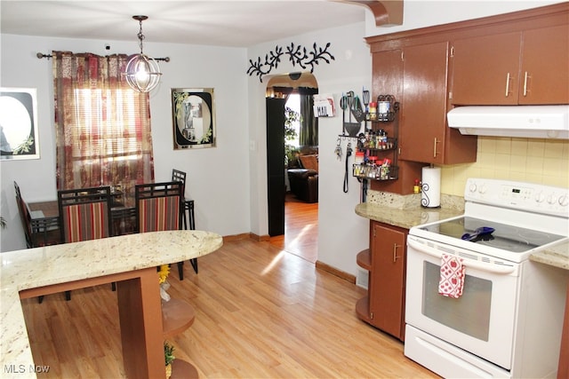 kitchen featuring tasteful backsplash, white electric stove, hanging light fixtures, and light wood-type flooring