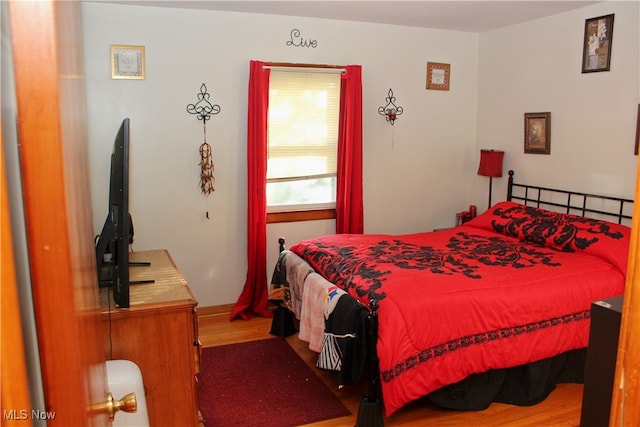 bedroom with wood-type flooring