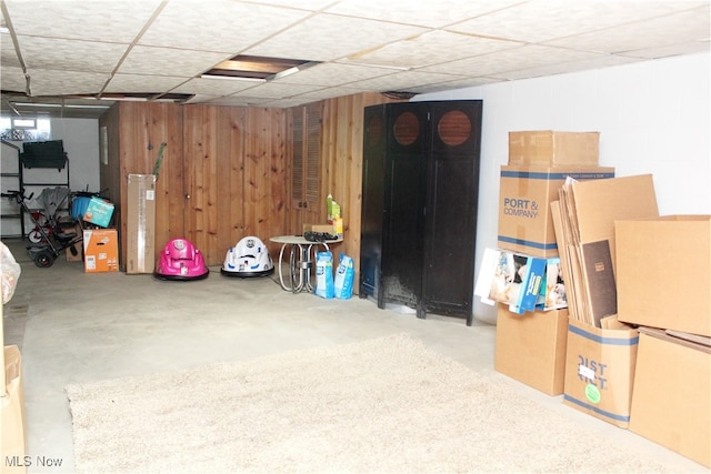 basement with water heater and wooden walls