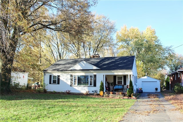 view of front of house with an outdoor structure, a front yard, a porch, and a garage