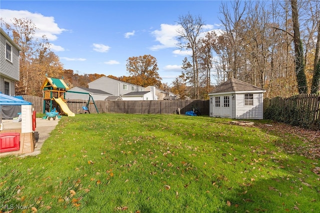 view of yard featuring a playground and a storage shed