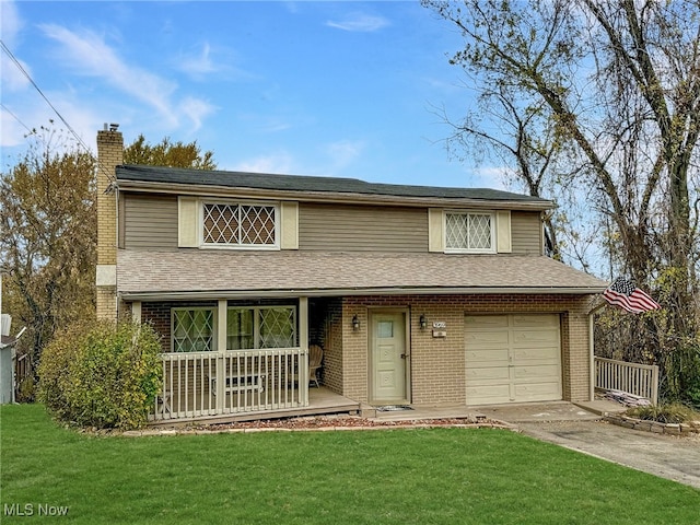 view of front facade with a garage, a porch, and a front yard