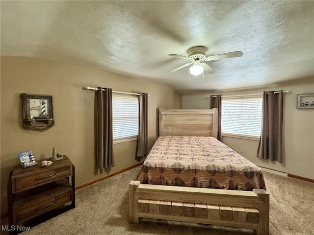 carpeted bedroom featuring a textured ceiling, multiple windows, and ceiling fan