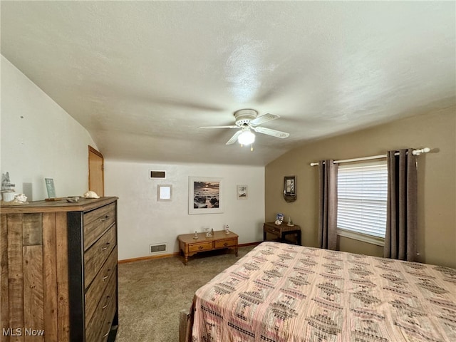 bedroom featuring carpet flooring, a textured ceiling, ceiling fan, and lofted ceiling