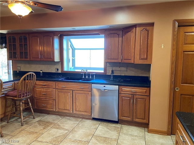 kitchen featuring dishwasher, tasteful backsplash, sink, and plenty of natural light