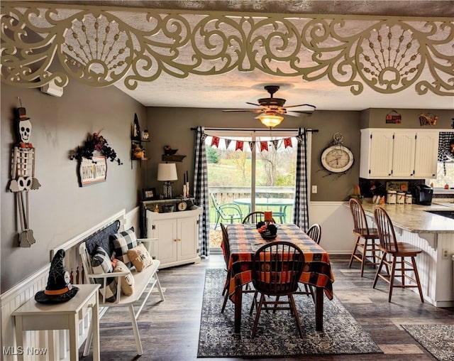 dining area with ceiling fan and dark hardwood / wood-style floors