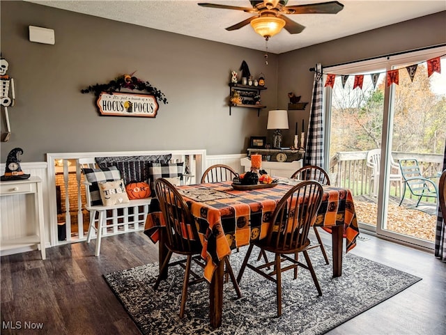 dining room with wood-type flooring, ceiling fan, and a textured ceiling