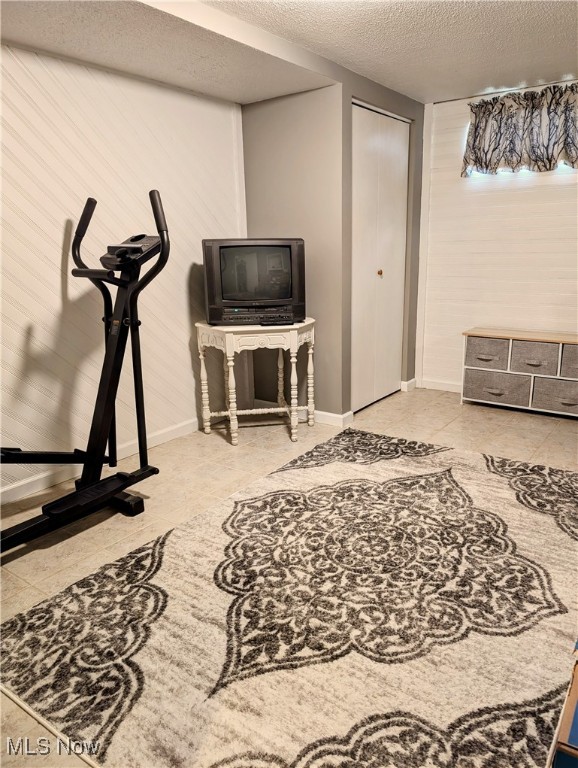 workout room with a textured ceiling